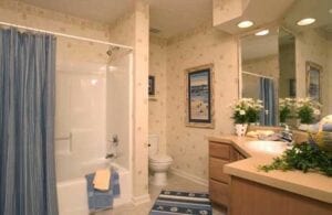 A bathtub covered by a blue shower curtain